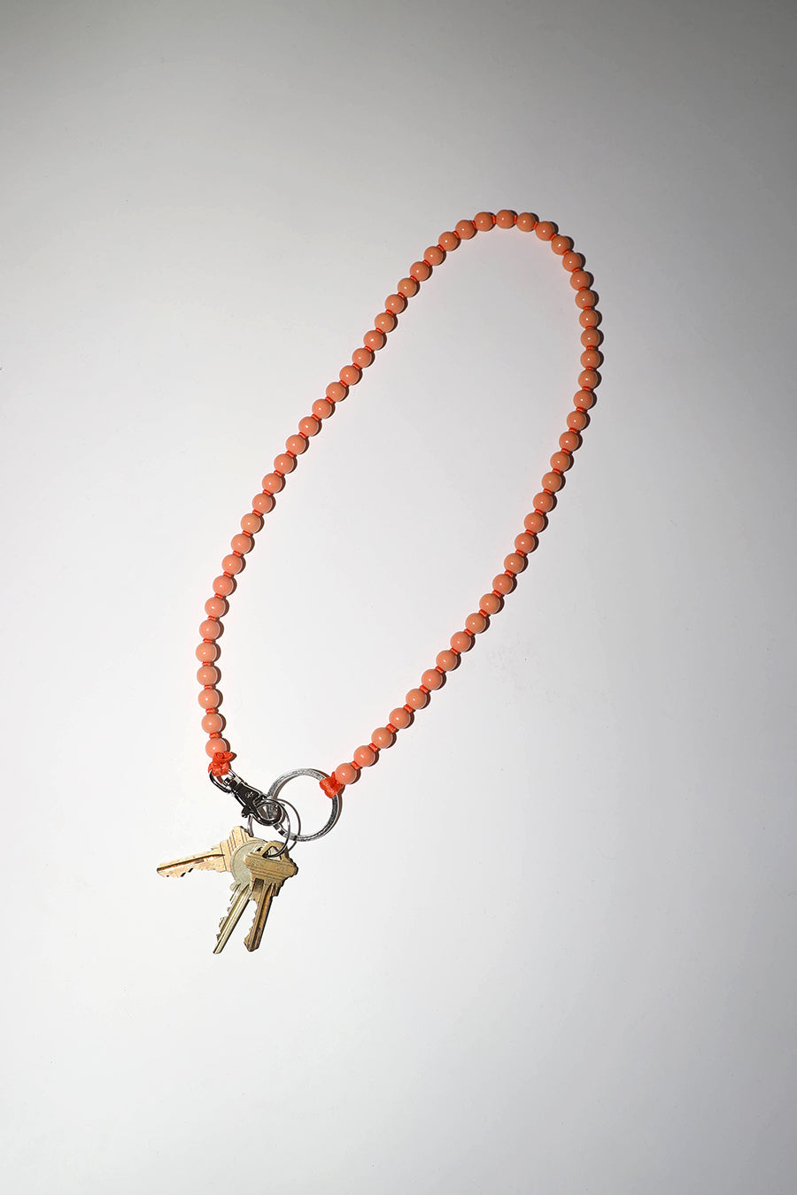 Ina Seifart Perlen Long Keyholder in Peach with Orange Thread