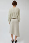 UMARMUNG Asymmetric Hem Skirt in Lamb